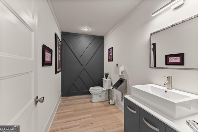 bathroom featuring hardwood / wood-style flooring, vanity, and toilet