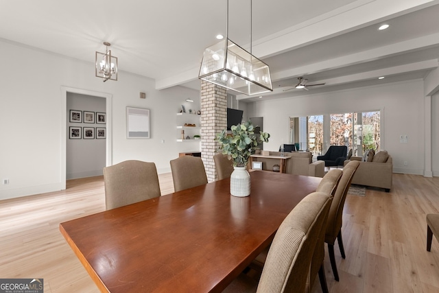 dining area featuring ceiling fan with notable chandelier, beam ceiling, and light hardwood / wood-style floors