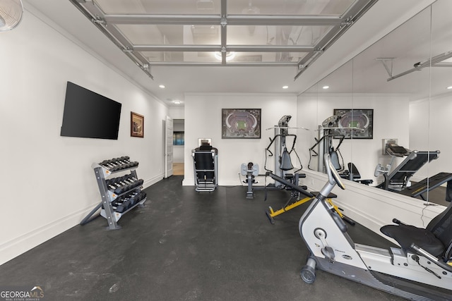 exercise room featuring crown molding