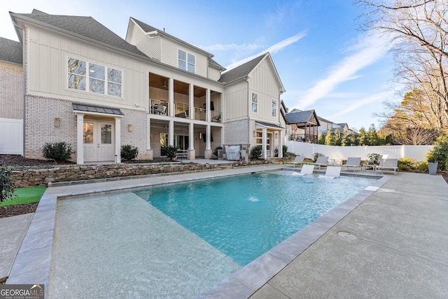 view of swimming pool featuring pool water feature and a patio area