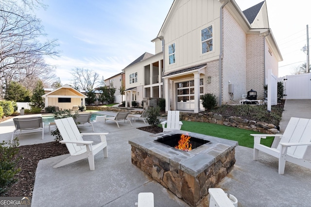 view of patio / terrace with an outbuilding and an outdoor fire pit