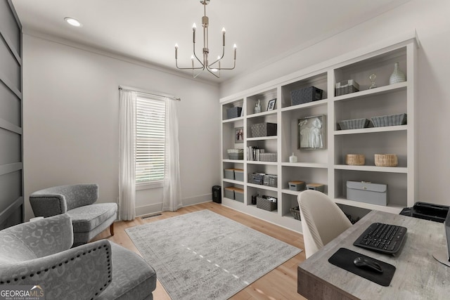 home office with a notable chandelier and light wood-type flooring