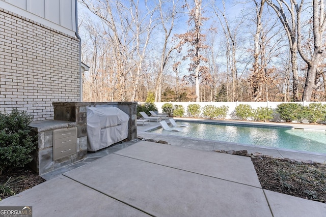 view of pool featuring area for grilling, grilling area, and a patio