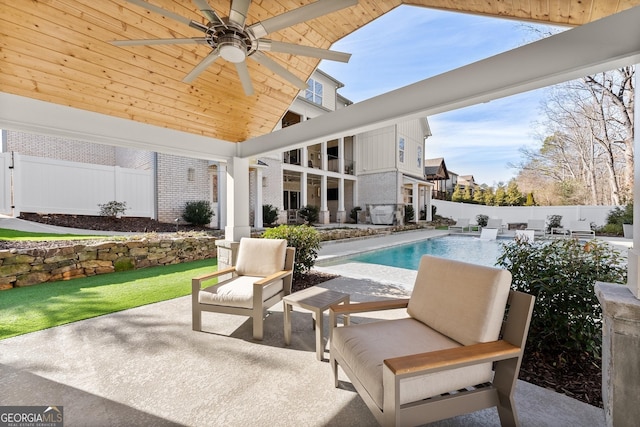 view of patio / terrace featuring a fenced in pool and ceiling fan