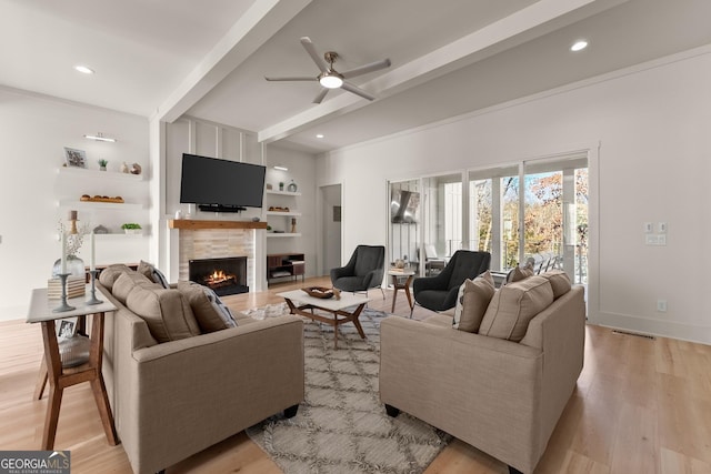 living room with ceiling fan, built in features, light hardwood / wood-style floors, and beamed ceiling