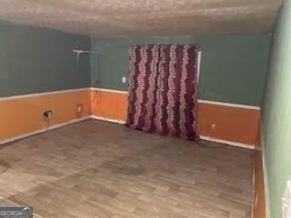 empty room with hardwood / wood-style floors