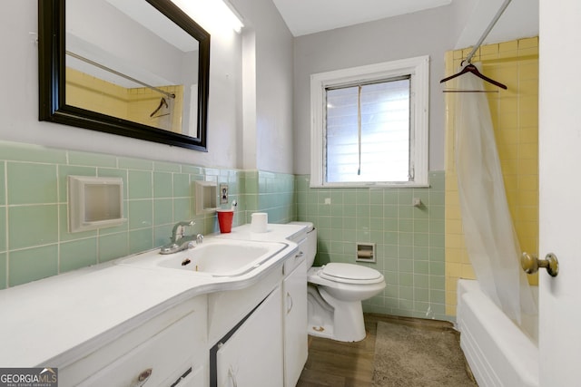 full bathroom featuring shower / bath combo, tile walls, vanity, and toilet