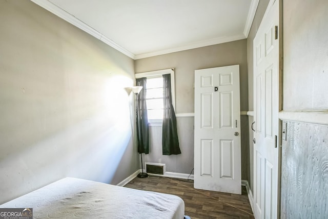 bedroom featuring crown molding and dark hardwood / wood-style flooring