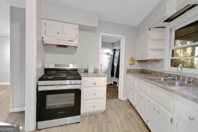 kitchen with white cabinetry, sink, light wood-type flooring, and stainless steel gas stove