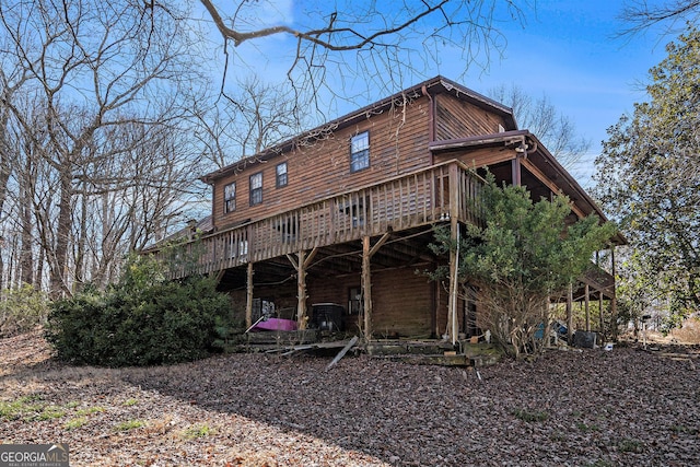 rear view of property with a wooden deck