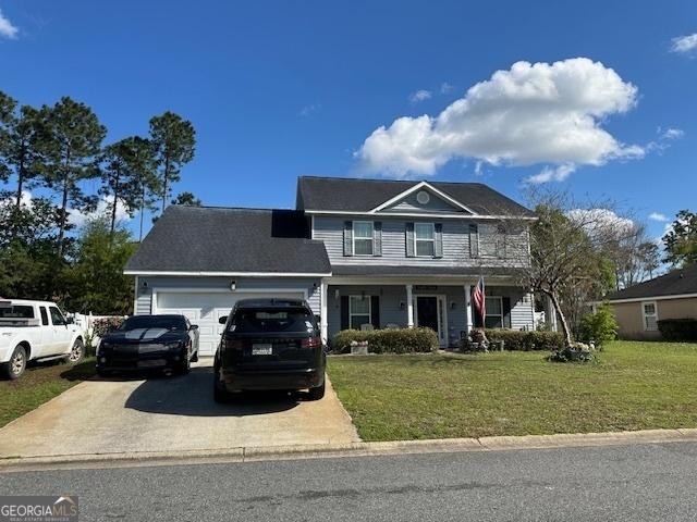 view of front of home with a garage and a front lawn