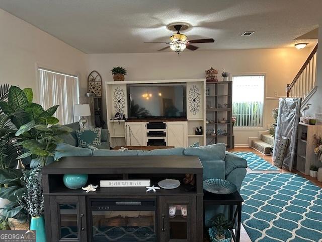 living room with ceiling fan and hardwood / wood-style floors