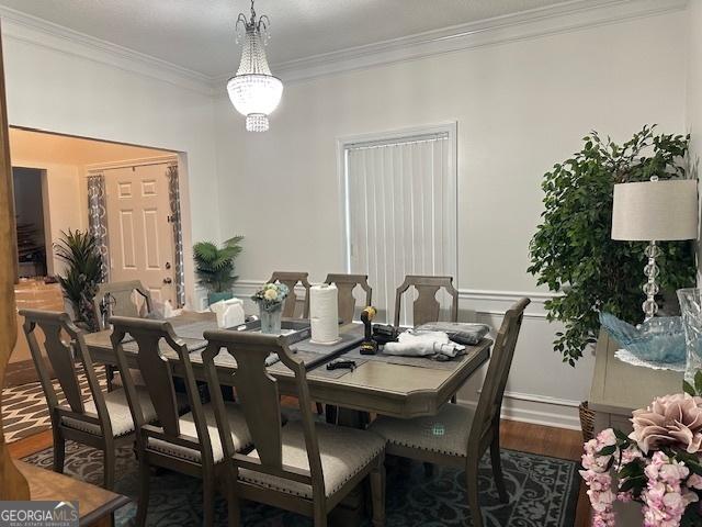 dining room featuring dark wood-type flooring and crown molding