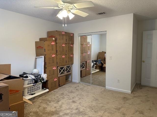 bedroom with carpet floors, a textured ceiling, and a closet