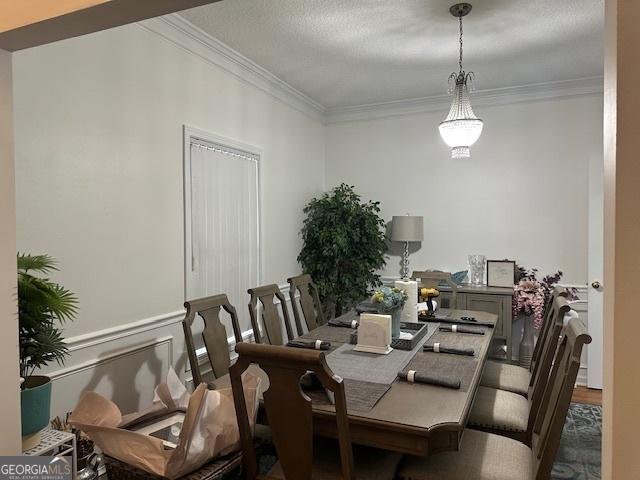 dining area with hardwood / wood-style floors and ornamental molding