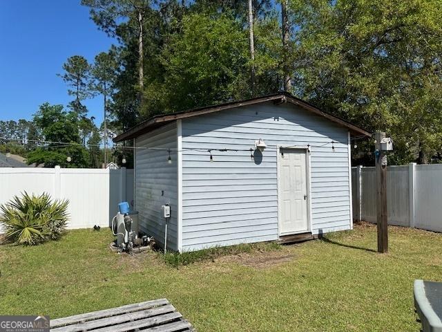 view of outbuilding featuring a yard