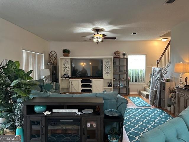 living room with hardwood / wood-style flooring and ceiling fan