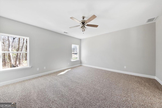 empty room featuring ceiling fan and carpet floors