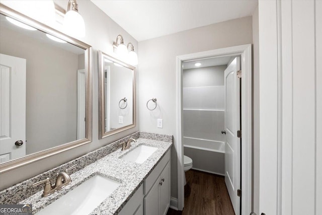 full bathroom featuring shower / tub combination, vanity, toilet, and wood-type flooring