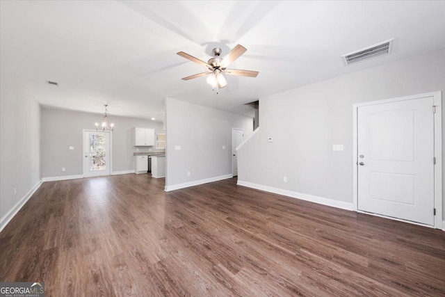 unfurnished living room featuring dark wood-type flooring and ceiling fan with notable chandelier