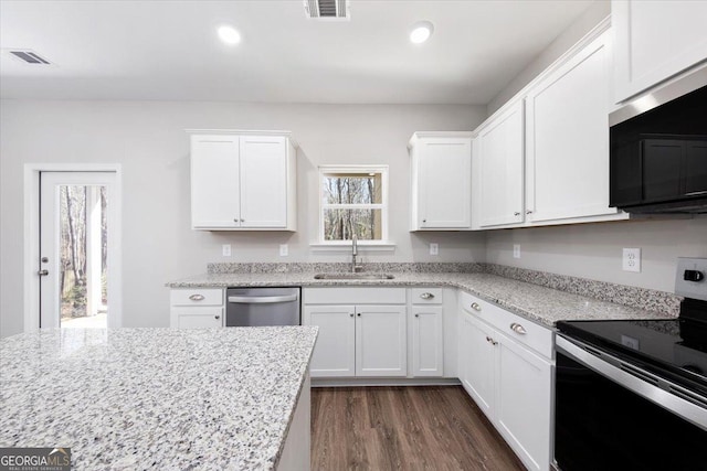 kitchen with appliances with stainless steel finishes, sink, and white cabinets