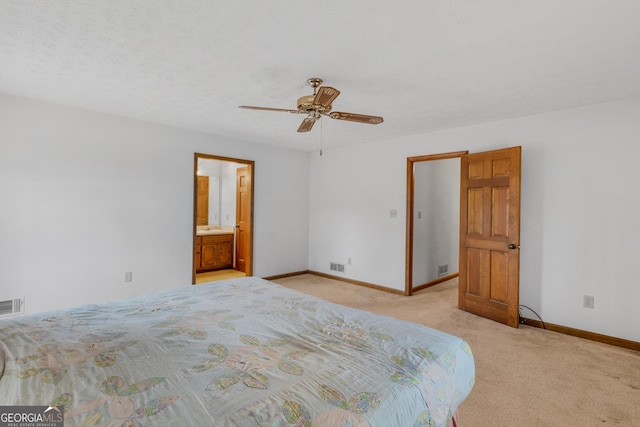 unfurnished bedroom featuring ceiling fan, light carpet, and a textured ceiling