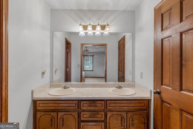 bathroom featuring vanity and a textured ceiling