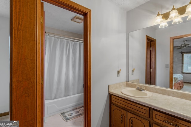 bathroom featuring vanity, shower / bathtub combination with curtain, tile patterned flooring, and a textured ceiling