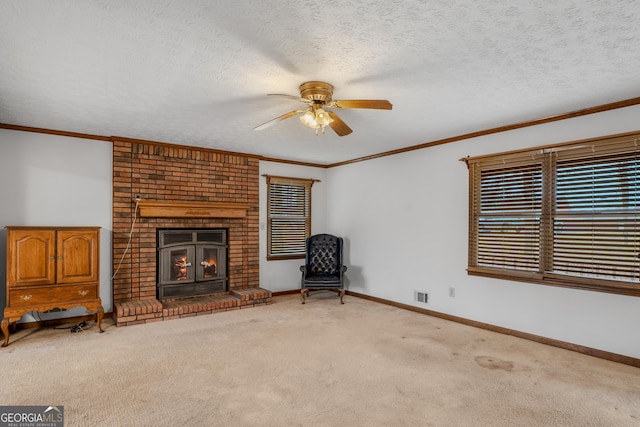 unfurnished living room with ornamental molding, carpet, a fireplace, and a textured ceiling