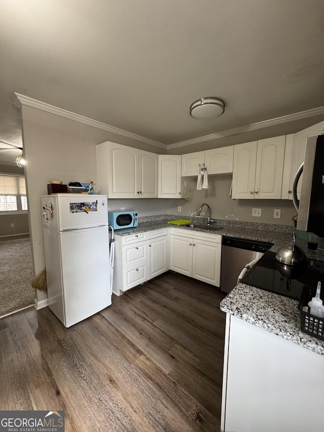 kitchen featuring white fridge, sink, stainless steel dishwasher, and white cabinets