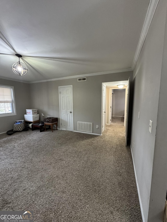 interior space with ornamental molding and carpet