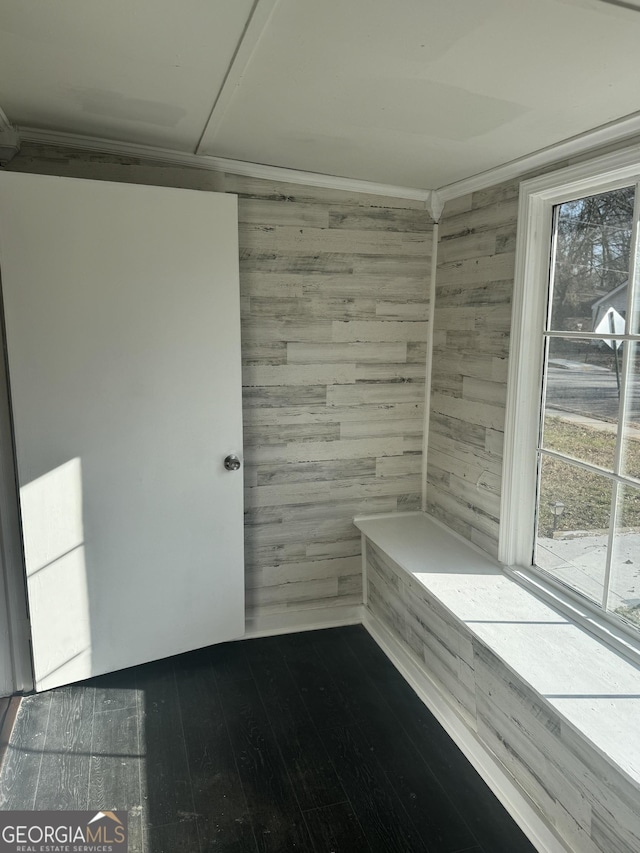 spare room with hardwood / wood-style flooring and wood walls