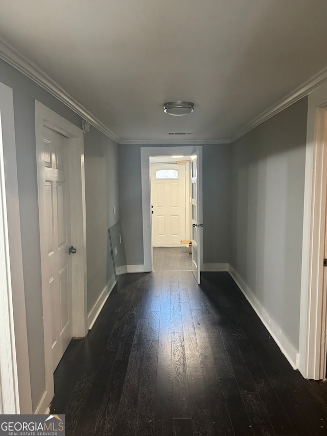 hallway featuring crown molding and dark hardwood / wood-style floors