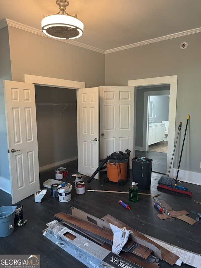 bedroom featuring crown molding, dark wood-type flooring, and a closet