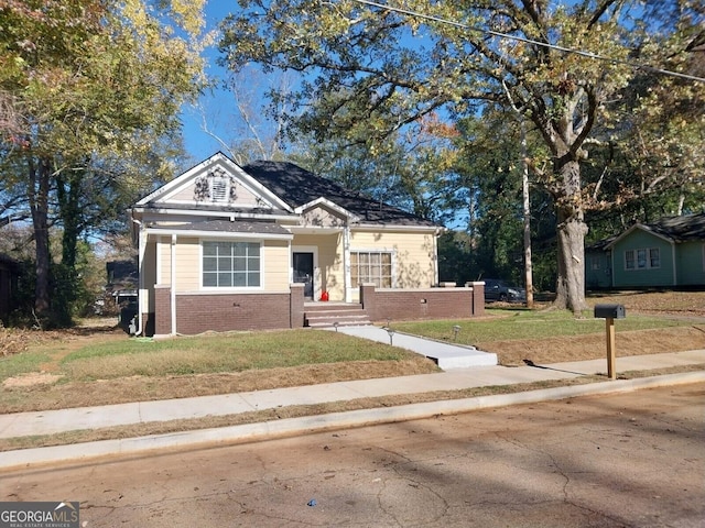 bungalow-style house with a front lawn