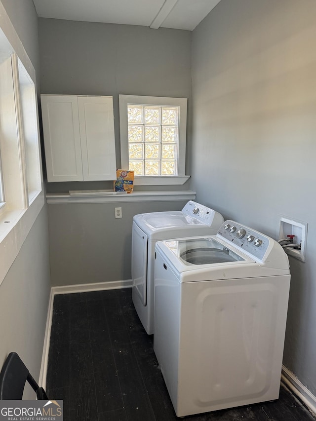 laundry area featuring separate washer and dryer and dark hardwood / wood-style floors