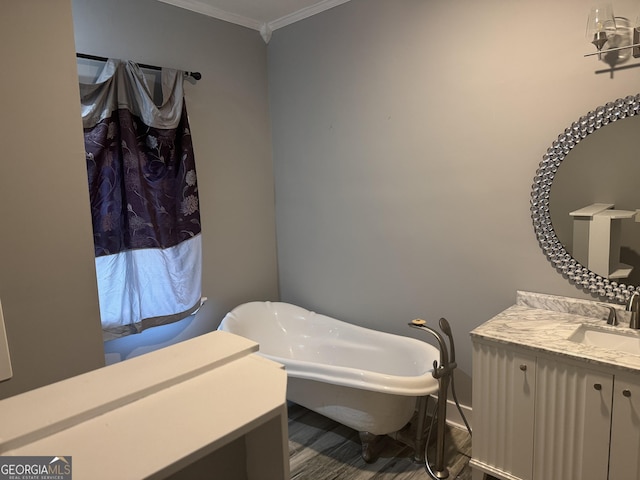 bathroom featuring ornamental molding, a bathtub, and vanity