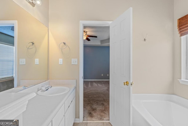 bathroom featuring a bathing tub, tile patterned floors, vanity, and ceiling fan