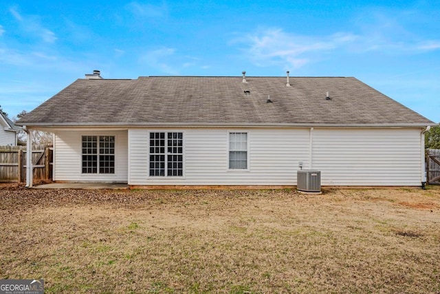 rear view of house with central AC, a yard, and a patio area