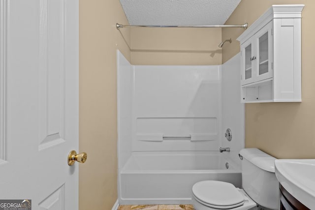 full bathroom featuring shower / bathtub combination, toilet, sink, and a textured ceiling