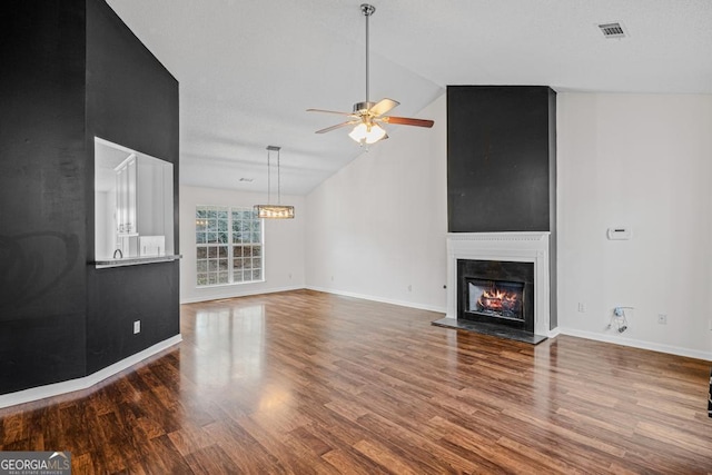 unfurnished living room featuring hardwood / wood-style flooring, high vaulted ceiling, and ceiling fan