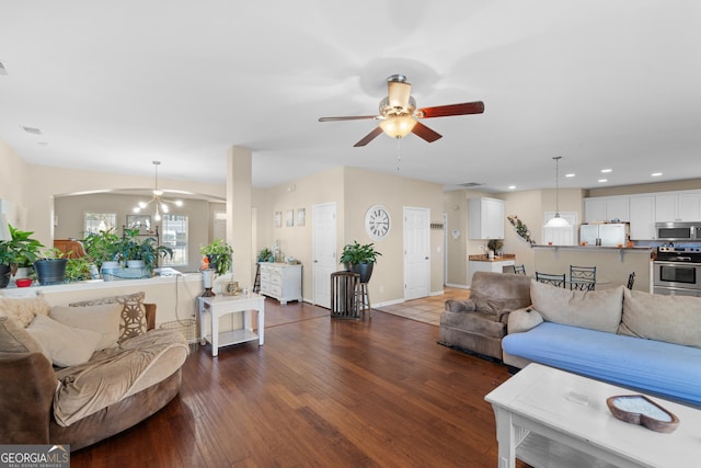 living room with ceiling fan and dark hardwood / wood-style flooring