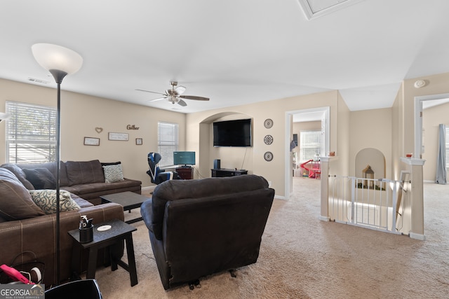 living room featuring light carpet and ceiling fan