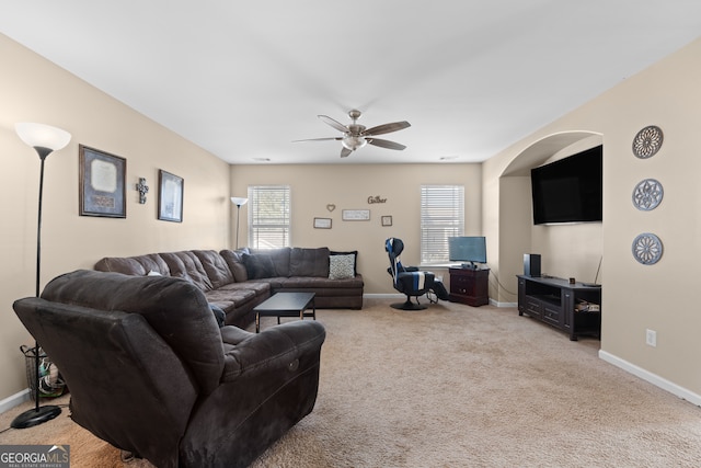 carpeted living room featuring ceiling fan