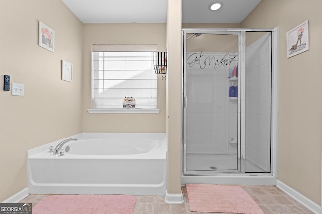 bathroom with independent shower and bath and tile patterned floors