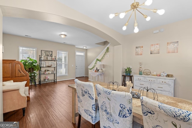 living room featuring a notable chandelier and dark hardwood / wood-style flooring