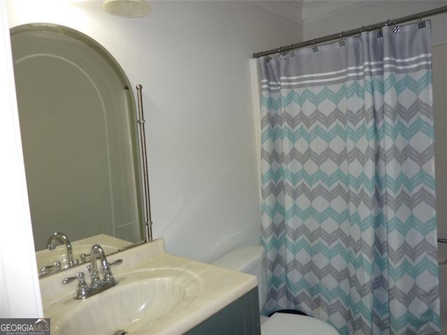 bathroom with a shower with curtain, ornamental molding, vanity, and toilet