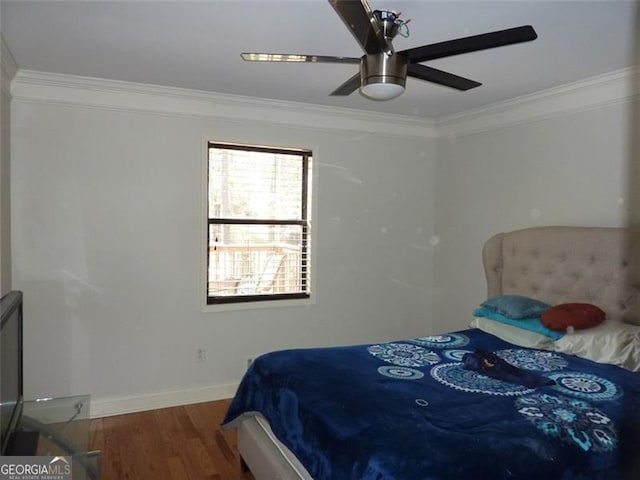 bedroom featuring hardwood / wood-style flooring, ornamental molding, and ceiling fan