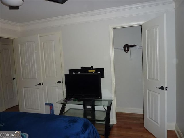 bedroom featuring dark hardwood / wood-style flooring and ornamental molding