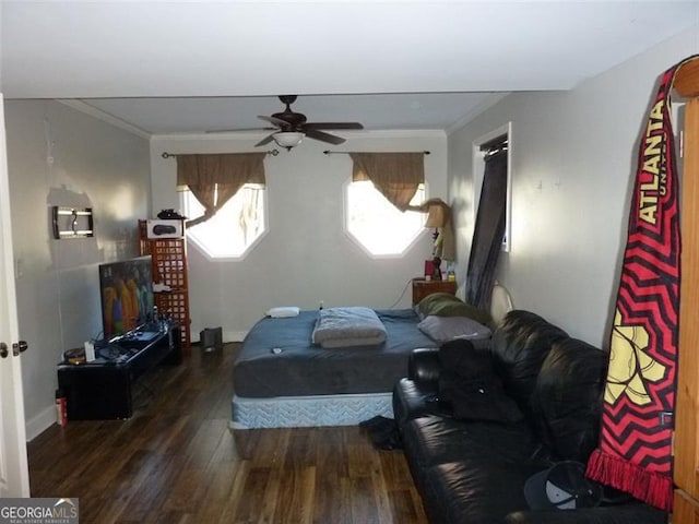 bedroom with ceiling fan, ornamental molding, and dark hardwood / wood-style floors